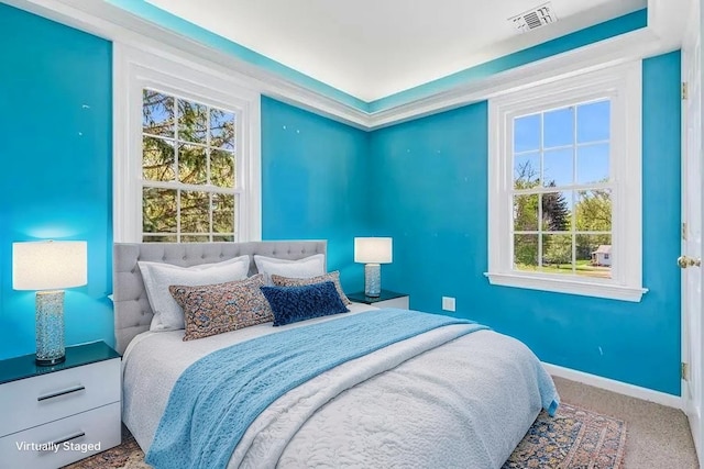 645 Hamilton Ave, Mattituck, NY 11952 - carpeted bedroom with multiple windows and baseboards