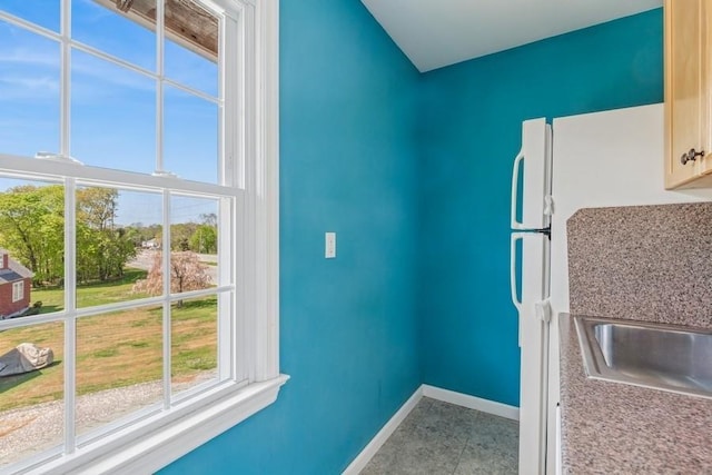 645 Hamilton Ave, Mattituck, NY 11952 - kitchen with baseboards and tile patterned flooring