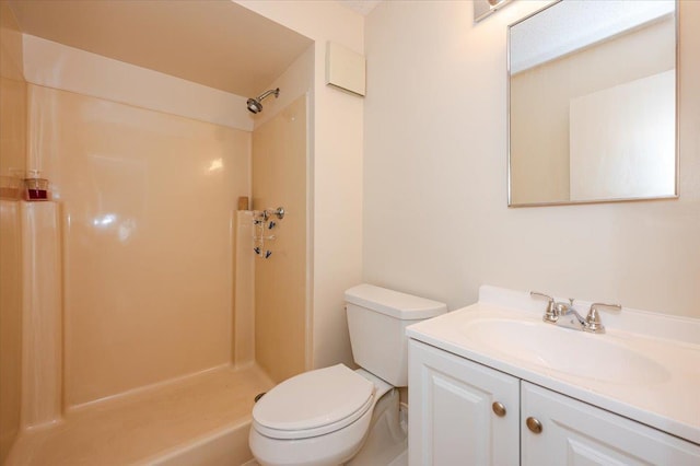bathroom featuring walk in shower, vanity, and toilet