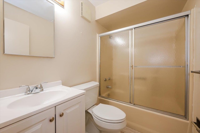 full bathroom featuring vanity, toilet, and enclosed tub / shower combo