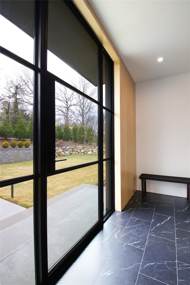 doorway to outside featuring recessed lighting and marble finish floor