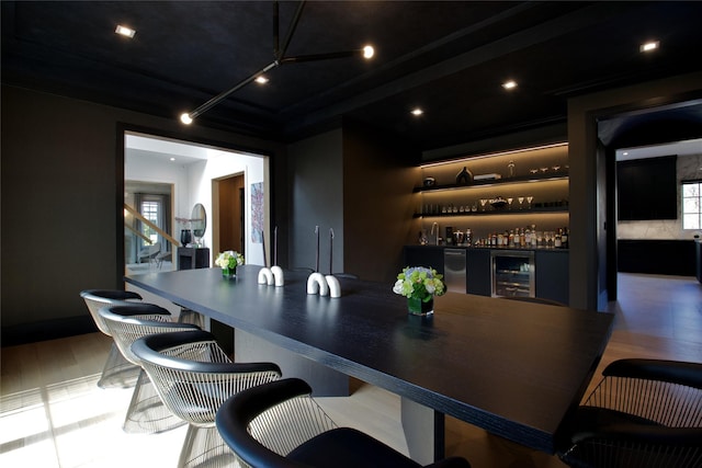 bar with a bar, recessed lighting, and beverage cooler