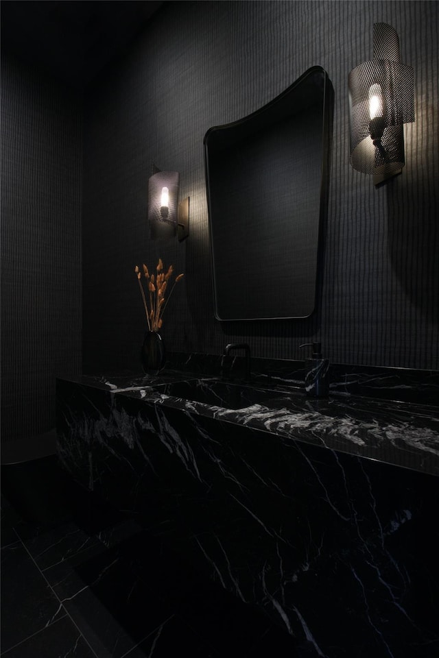 home theater with marble finish floor and wallpapered walls