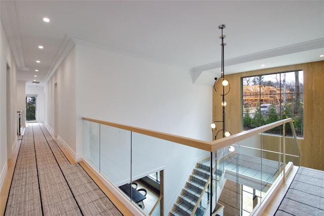corridor with plenty of natural light, ornamental molding, and recessed lighting