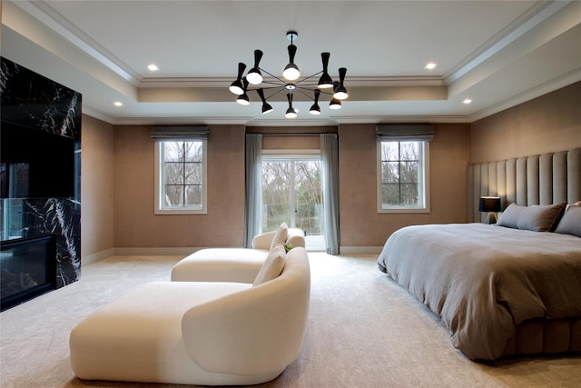 carpeted bedroom featuring a raised ceiling, ornamental molding, baseboards, and access to exterior