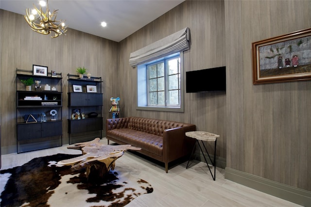 living area with baseboards and a chandelier