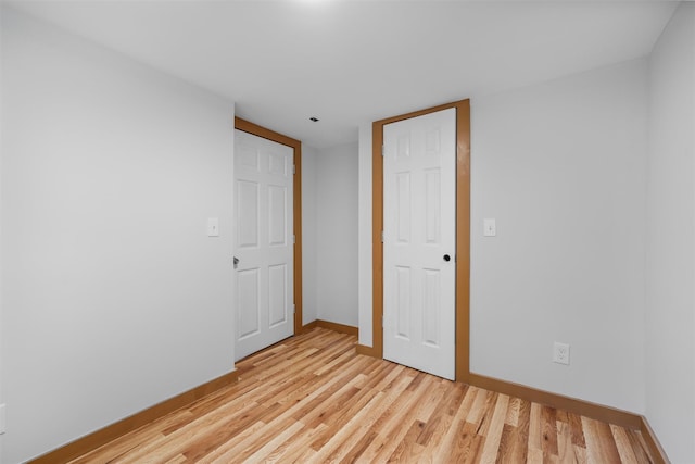 unfurnished bedroom featuring light wood finished floors and baseboards