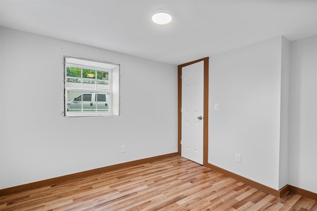 unfurnished room with light wood-style floors and baseboards