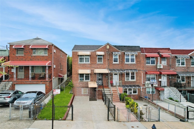 2959 Laconia Ave, Bronx, NY 10469 - townhome / multi-family property featuring a gate, brick siding, and a garage