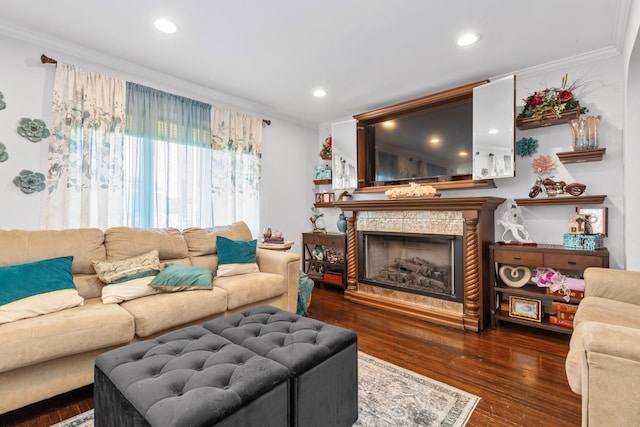 living area with recessed lighting, ornamental molding, hardwood / wood-style flooring, and a fireplace