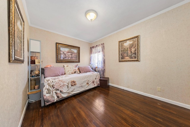 bedroom with baseboards, ornamental molding, and wood finished floors