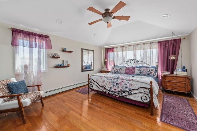 bedroom with ceiling fan, recessed lighting, wood finished floors, lofted ceiling, and a baseboard radiator