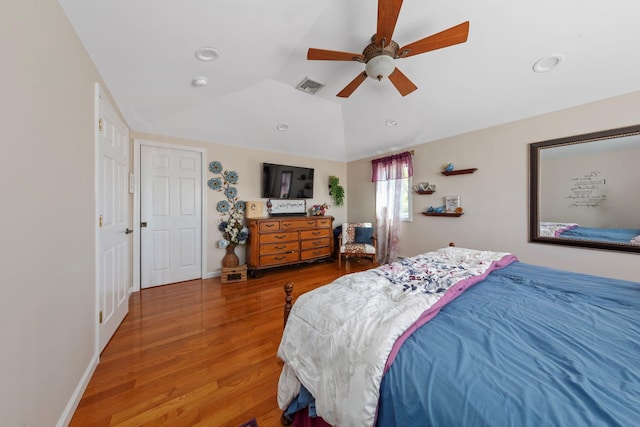 bedroom with recessed lighting, visible vents, wood finished floors, and vaulted ceiling