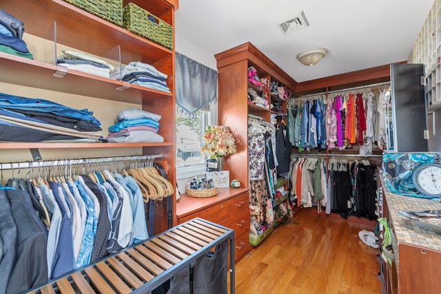 spacious closet with visible vents and wood finished floors
