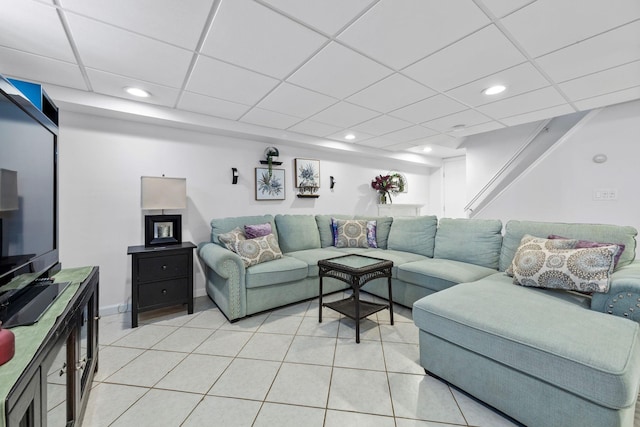 living room with recessed lighting, a paneled ceiling, and light tile patterned floors