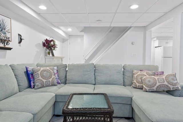 living area featuring recessed lighting and a paneled ceiling