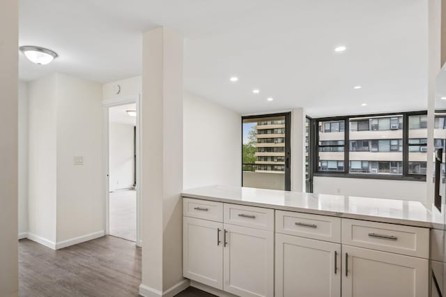 bar area with wood finished floors, baseboards, and recessed lighting