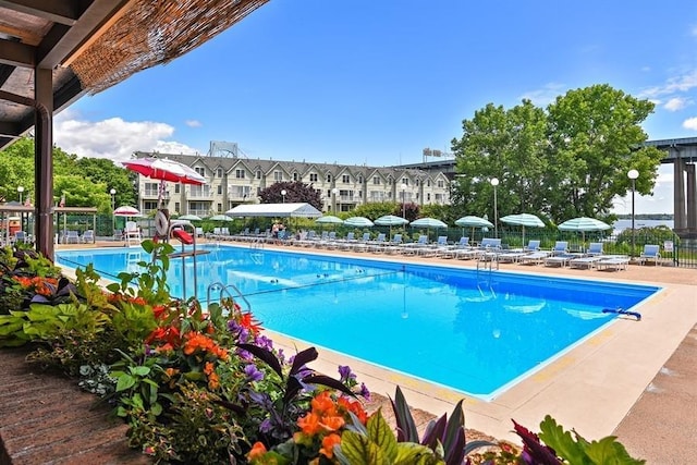 community pool featuring fence and a patio