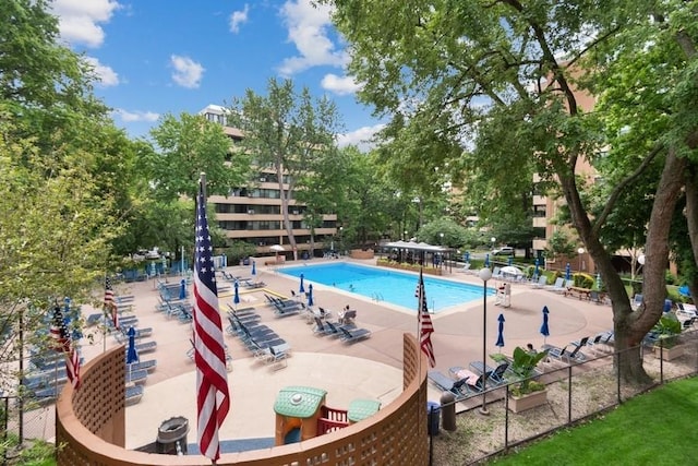 view of pool with view of wooded area