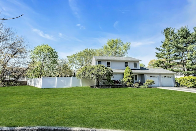 view of front of house with driveway, fence, a front lawn, and a garage