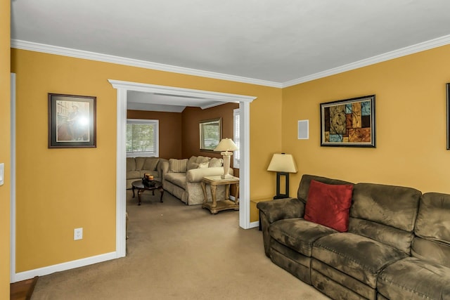 carpeted living room with baseboards and ornamental molding