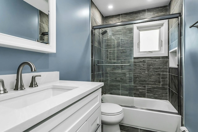 full bath with toilet, enclosed tub / shower combo, and vanity