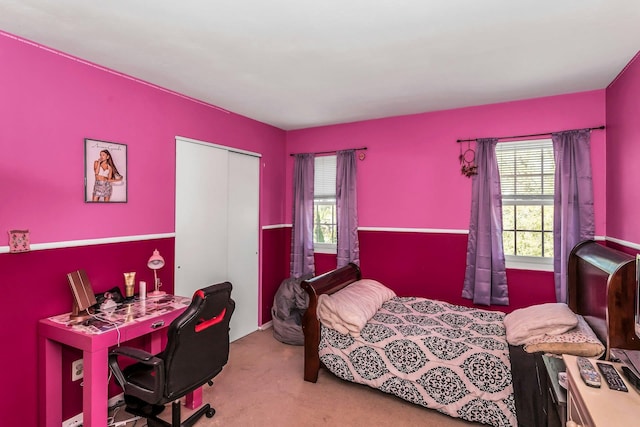 bedroom featuring carpet floors, multiple windows, and a closet