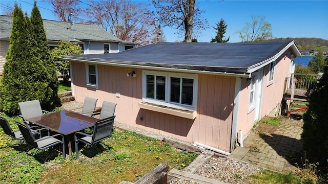 rear view of house featuring outdoor dining space