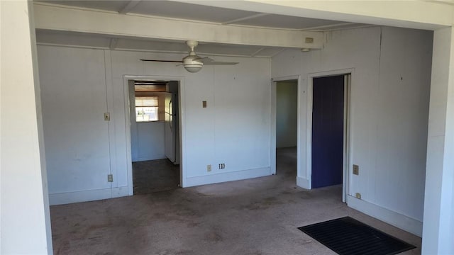 unfurnished room with baseboards, carpet, and a ceiling fan
