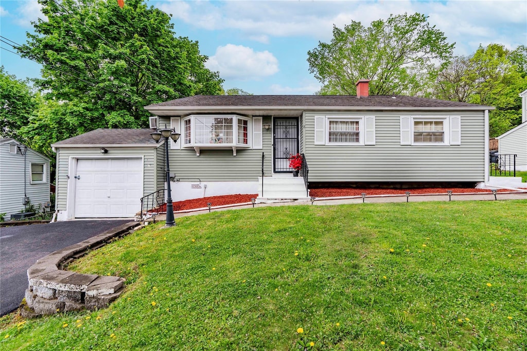 8 Neversink Dr, Newburgh, NY 12550 - single story home with a front yard, a chimney, driveway, and a garage