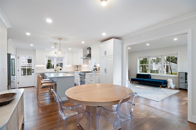 dining room featuring crown molding, dark wood-style flooring, and recessed lighting