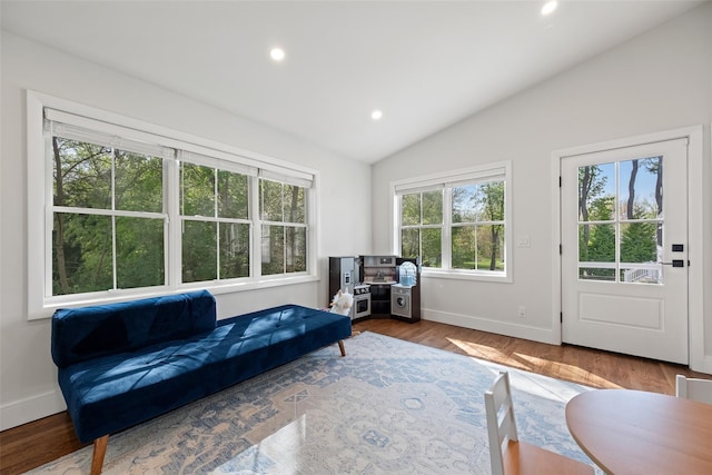 living area featuring baseboards, recessed lighting, lofted ceiling, and wood finished floors