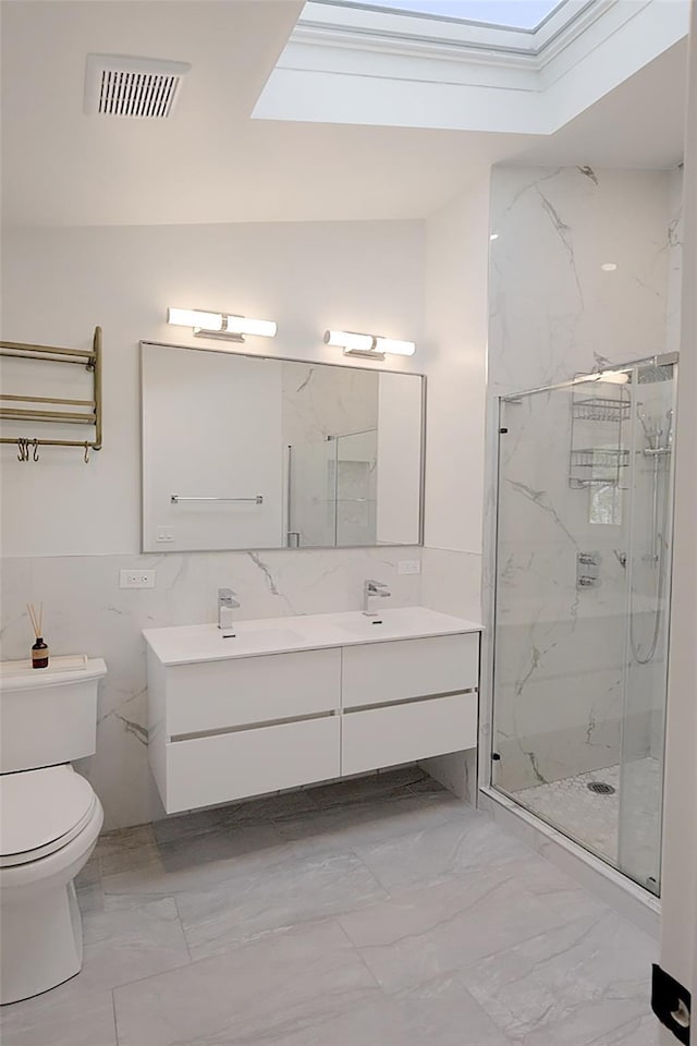 full bath with a skylight, marble finish floor, a sink, and visible vents