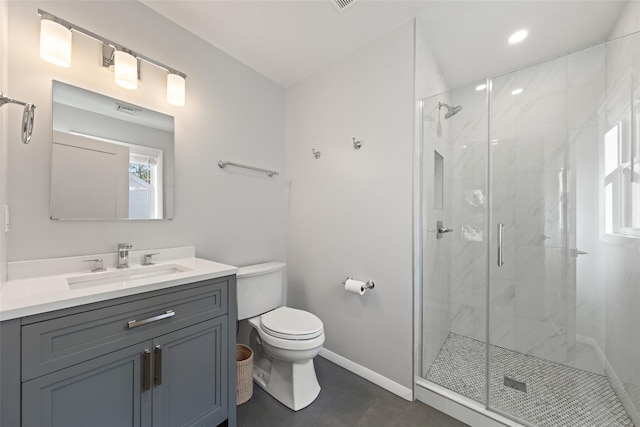 bathroom with vanity, a marble finish shower, baseboards, and toilet