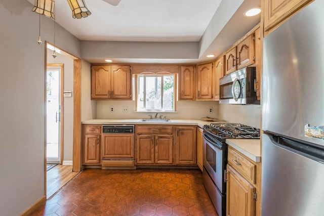 kitchen featuring recessed lighting, a sink, appliances with stainless steel finishes, and light countertops