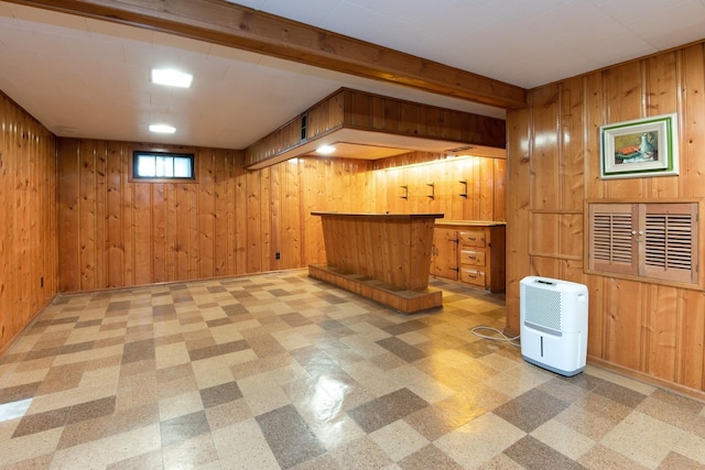 below grade area with wood walls and light floors