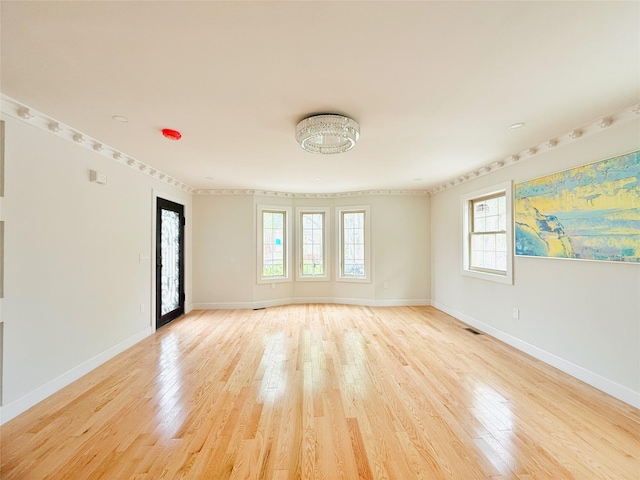 103-22 104th St, Ozone Park, NY 11417 - empty room with baseboards, ornamental molding, and light wood finished floors