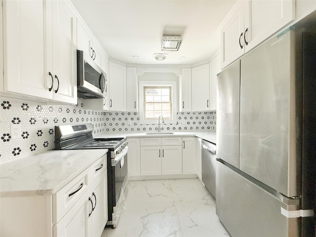103-22 104th St, Ozone Park, NY 11417 - kitchen with backsplash, appliances with stainless steel finishes, a sink, marble finish floor, and white cabinetry