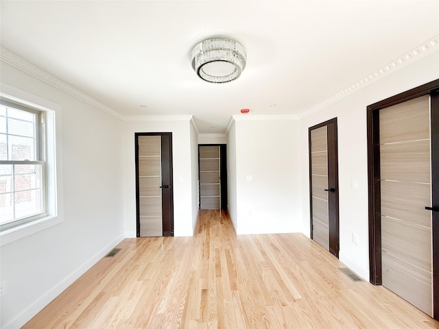 103-22 104th St, Ozone Park, NY 11417 - unfurnished bedroom with light wood-style floors, baseboards, crown molding, and visible vents