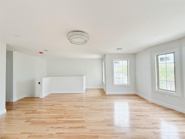 103-22 104th St, Ozone Park, NY 11417 - unfurnished living room with baseboards, visible vents, and light wood-style flooring