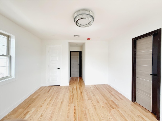 103-22 104th St, Ozone Park, NY 11417 - spare room featuring baseboards, visible vents, and light wood-style flooring