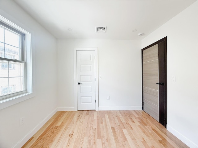 103-22 104th St, Ozone Park, NY 11417 - unfurnished bedroom with visible vents, light wood-style flooring, baseboards, and a closet
