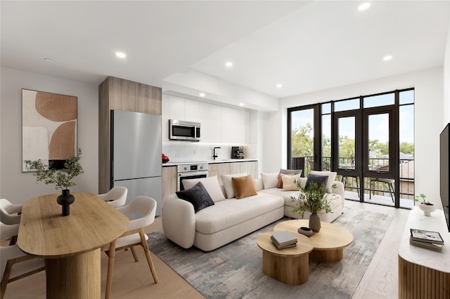 living area featuring recessed lighting and light wood finished floors