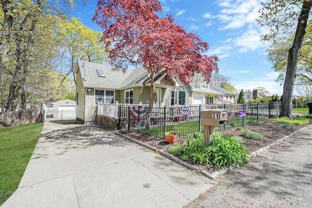 view of front of property with roof with shingles, a garage, fence, a front lawn, and concrete driveway