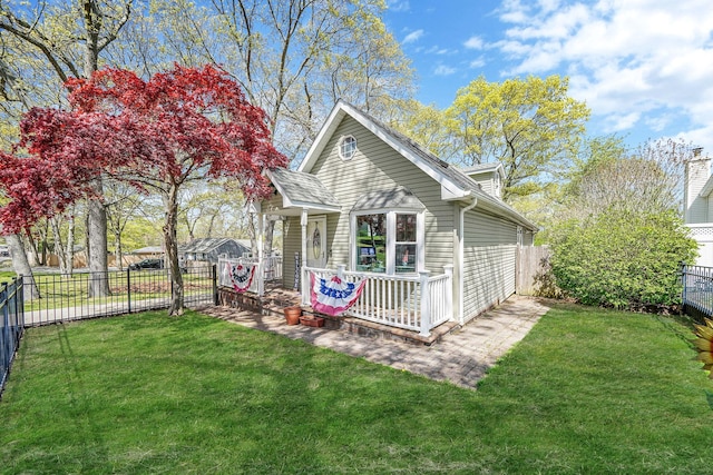 exterior space featuring a fenced backyard, covered porch, and a lawn