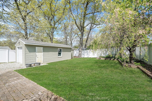 view of yard featuring an outdoor structure and a fenced backyard