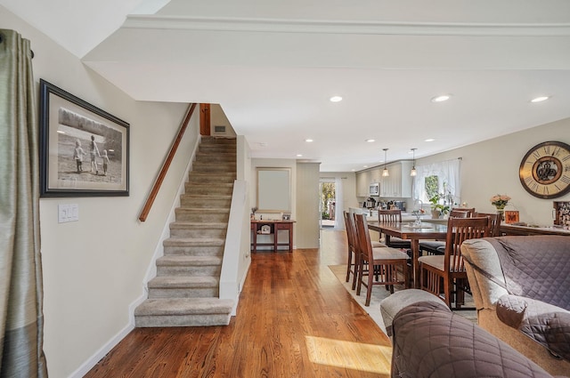 dining space featuring stairs, recessed lighting, baseboards, and light wood finished floors