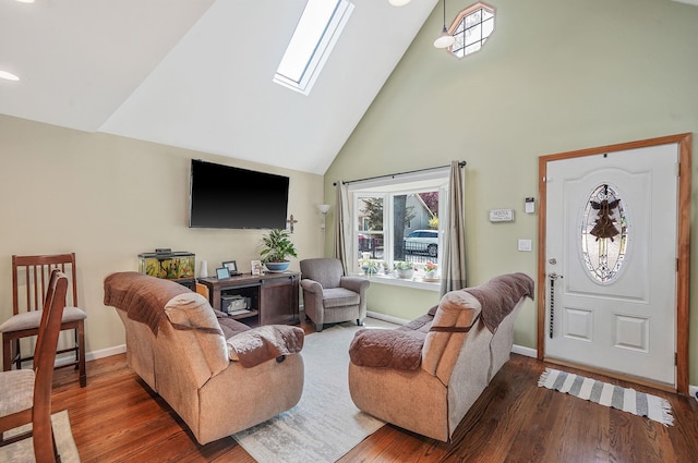 living area featuring a skylight, a wealth of natural light, high vaulted ceiling, and wood finished floors
