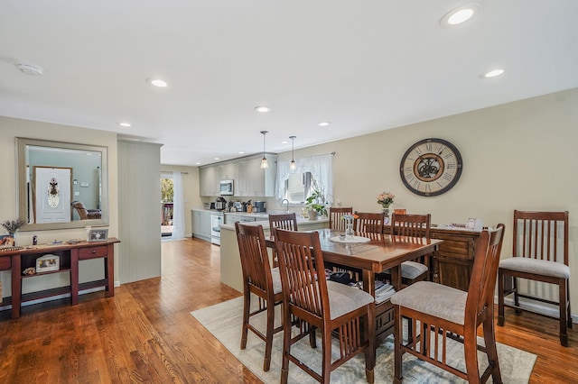 dining area featuring recessed lighting, a healthy amount of sunlight, and wood finished floors