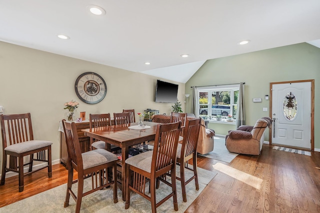 dining area featuring recessed lighting, baseboards, vaulted ceiling, and wood finished floors